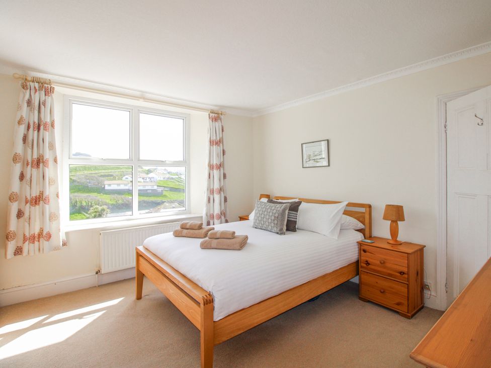 A bedroom with a bed and a bedside table at Eddystone in Hope Cove