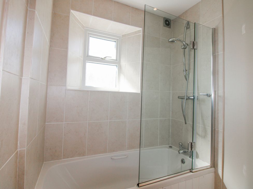A bathroom with a bathtub and shower at Eddystone in Hope Cove