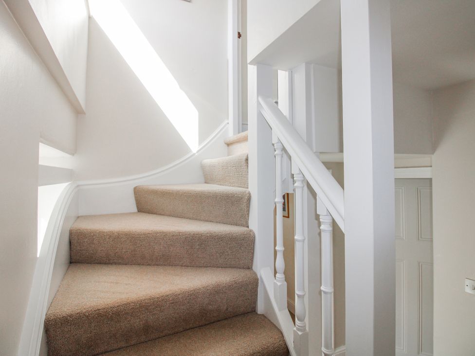 A staircase with carpet and railing at Eddystone in Hope Cove