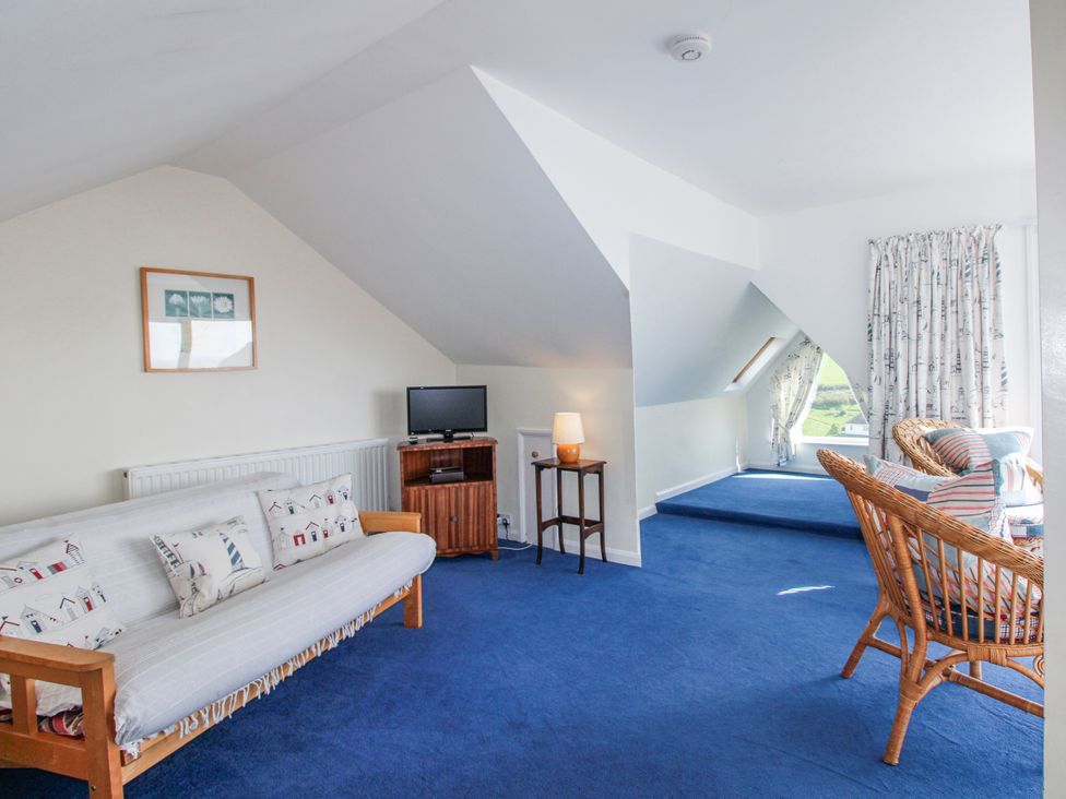 A living room with a sofa and television at Eddystone in Hope Cove
