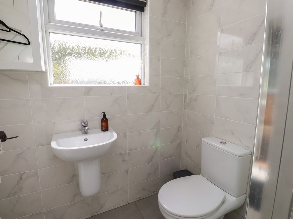 A bathroom with a sink and toilet at Bro Mebyd in Criccieth