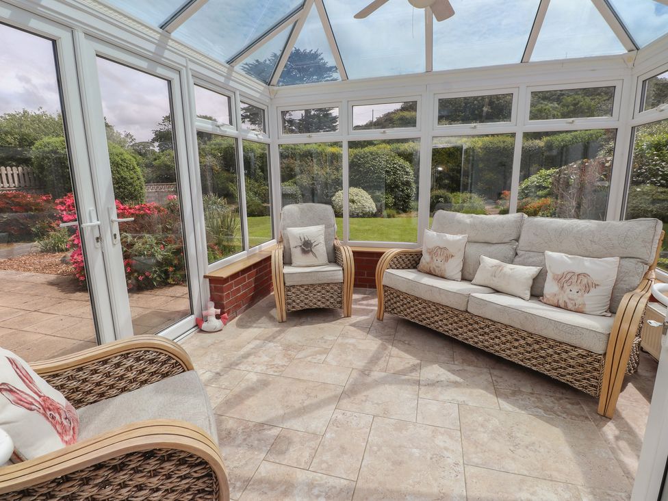 A conservatory with seating area at Bro Mebyd in Criccieth