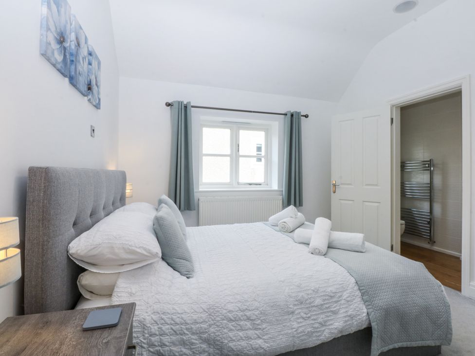 A bedroom with a bed and window at Capel Y Ffynnon near Llandudno Junction