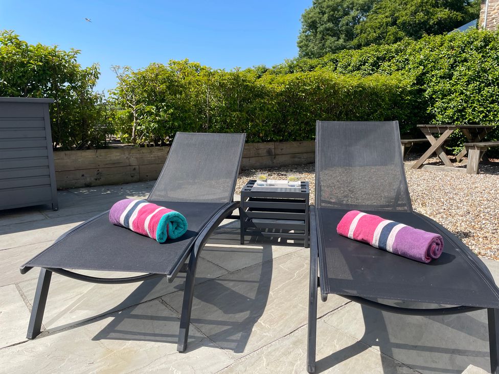 Two lounge chairs with towels in an outdoor area at 2 The Manor House, Hillfield Village Dartmouth