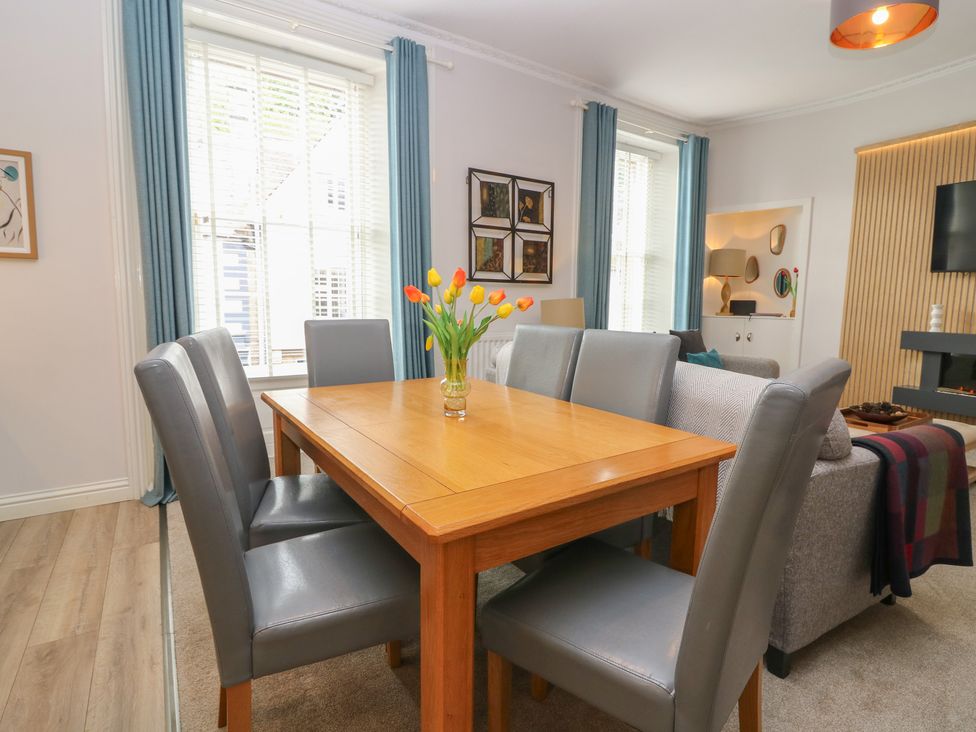 A dining room with a table and chairs at 2 Abbey Row in Kelso