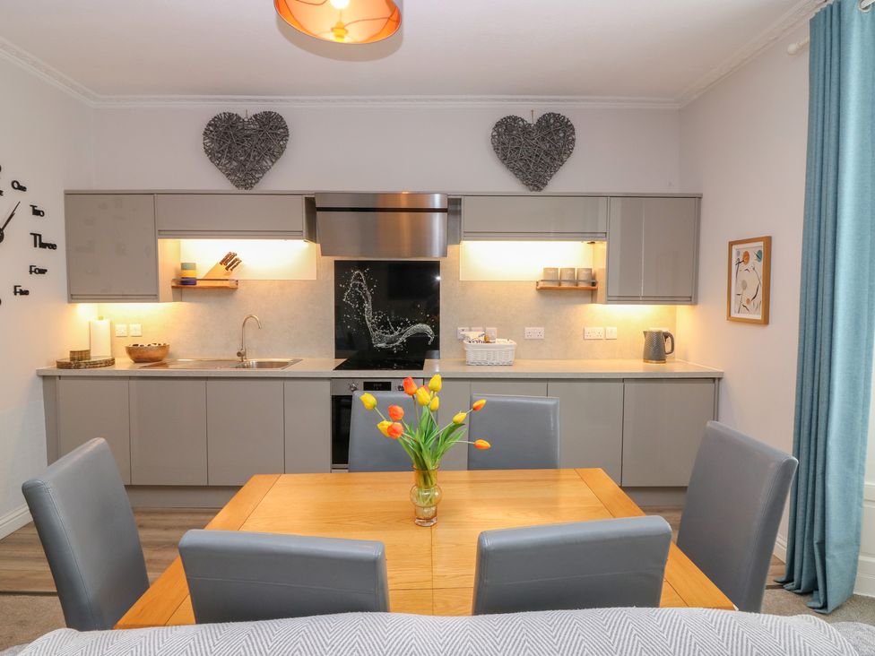 A kitchen with a dining table and chairs at 2 Abbey Row Kelso