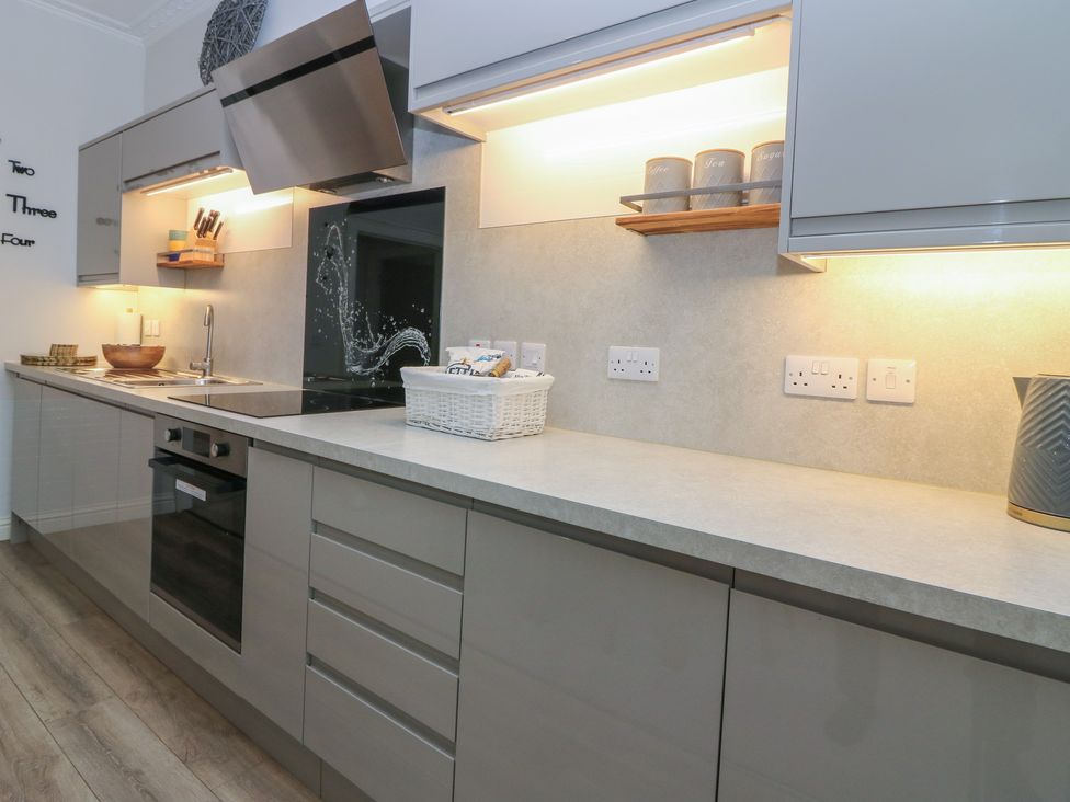 A kitchen with a sink and oven at 2 Abbey Row in Kelso