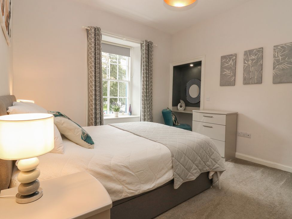 A bedroom with a bed and dresser at 2 Abbey Row in Kelso