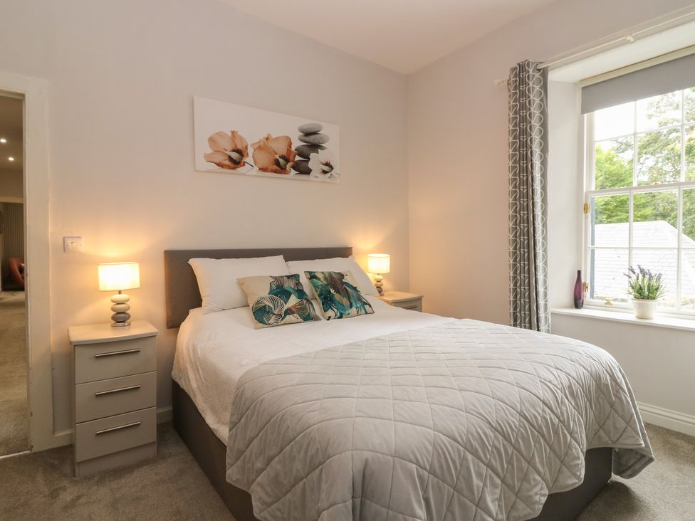 A bedroom with a bed and bedside table at 2 Abbey Row, Kelso