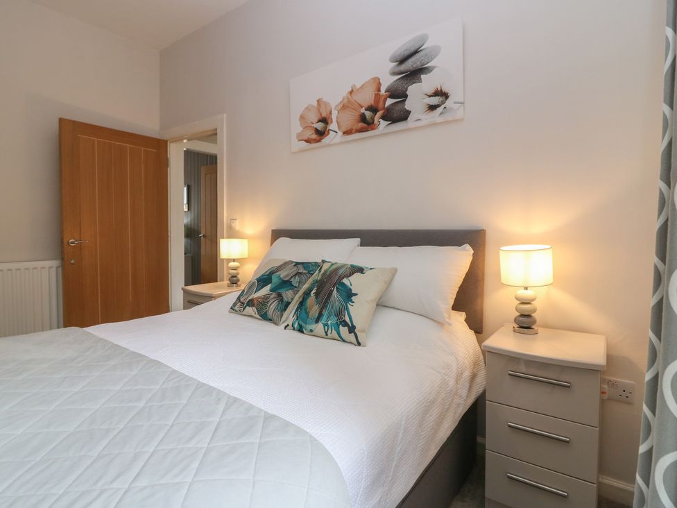 A bedroom with a bed and bedside table at 2 Abbey Row in Kelso