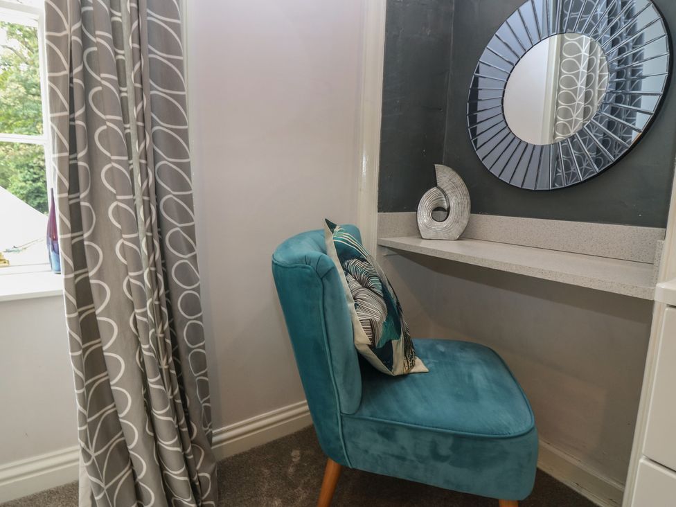 A chair and mirror in a home office at 2 Abbey Row in Kelso