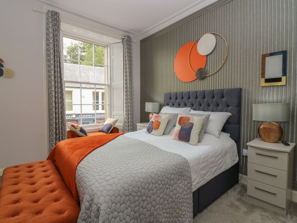 A bedroom with a bed and decorative items at 2 Abbey Row in Kelso