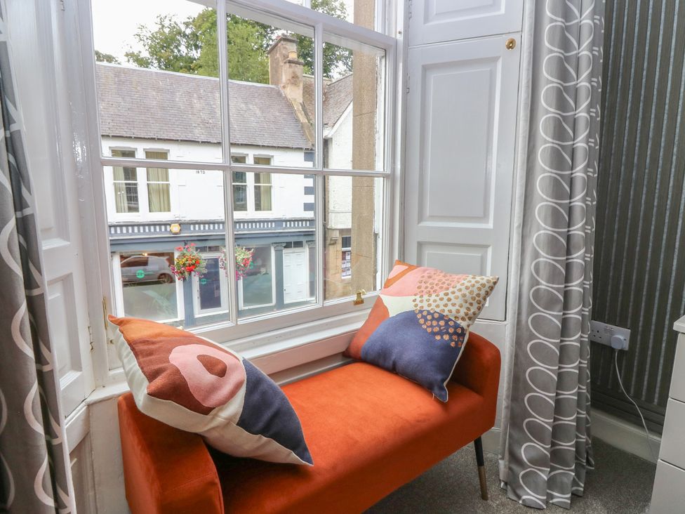 A living room with a couch and window at 2 Abbey Row Kelso