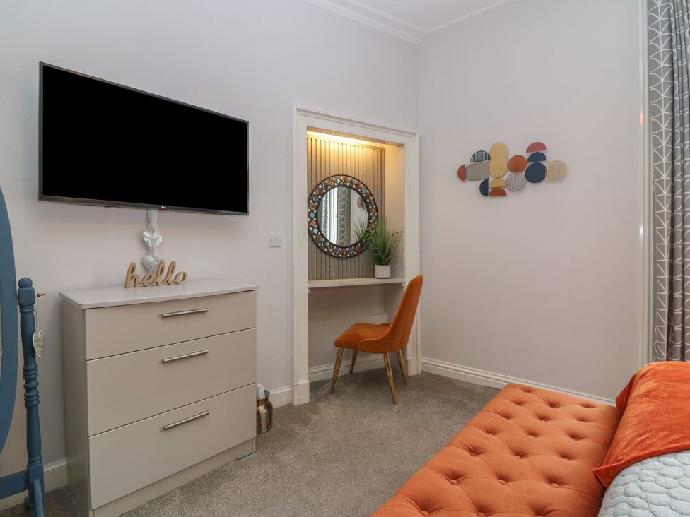 A bedroom with a television and a dresser at 2 Abbey Row in Kelso