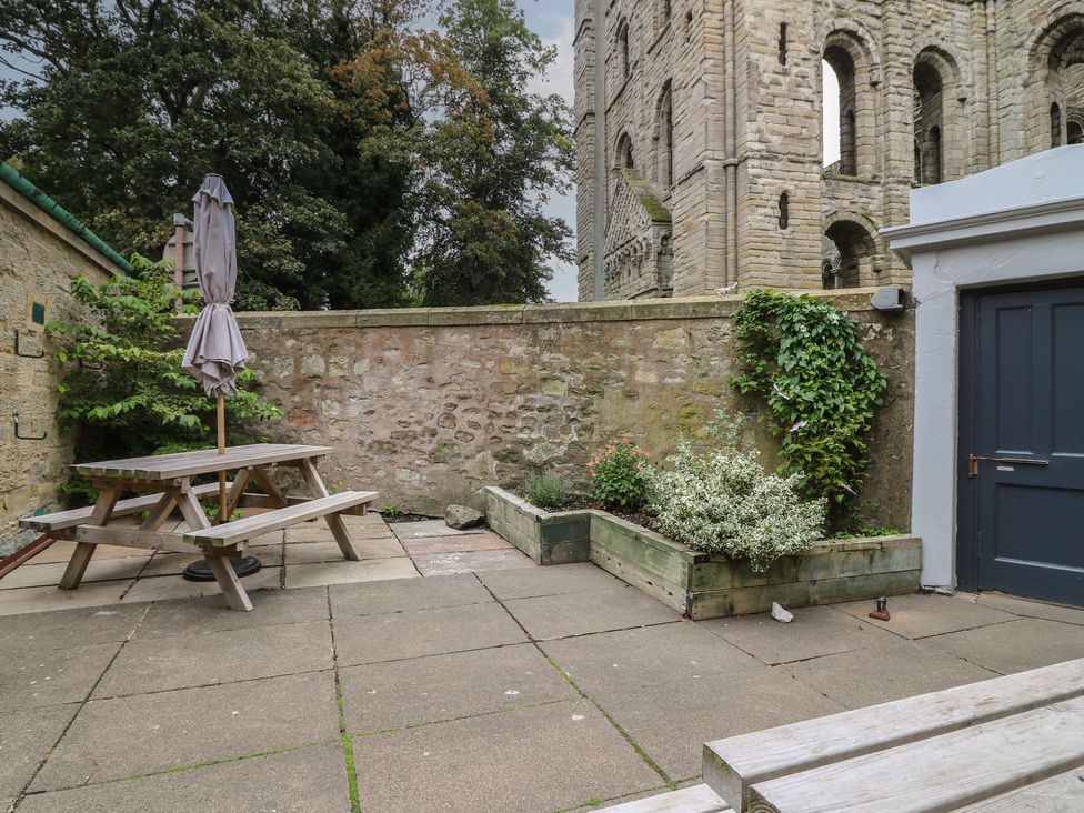 A garden with a picnic table and plants at 2 Abbey Row in Kelso