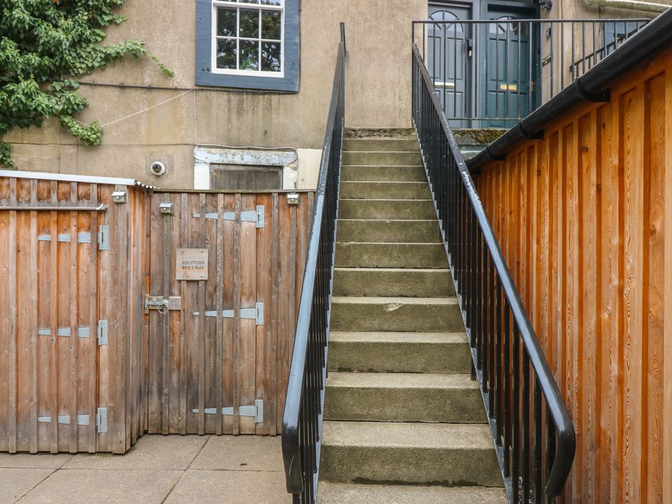 Stairs leading to a door with a wooden gate at 2 Abbey Row Kelso