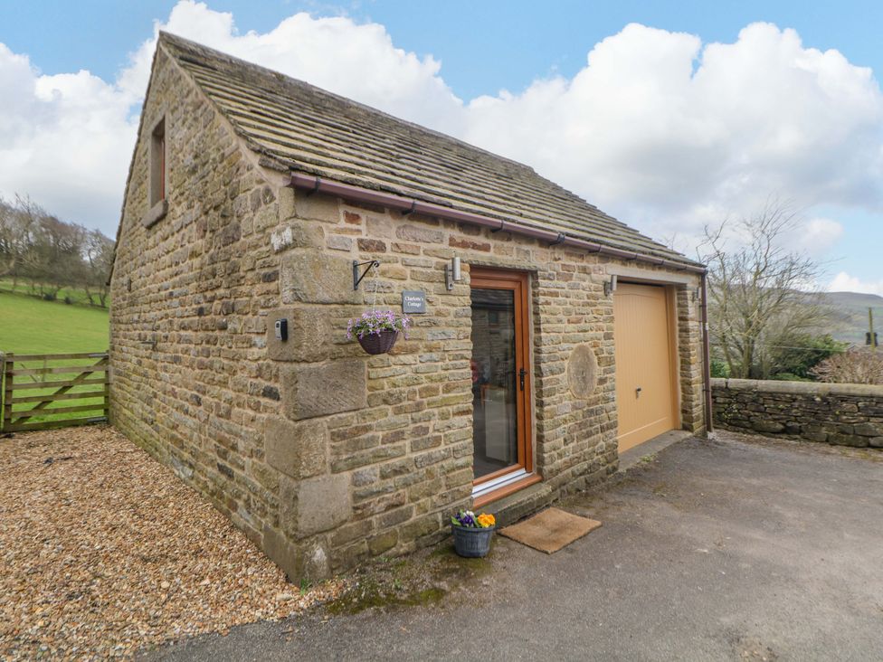 A cottage with a door and window in Charlotte’s Cottage Hathersage