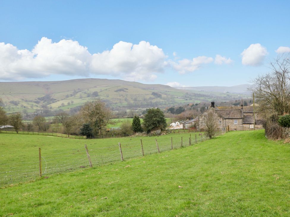 A rural landscape with a house and hills at Charlotte’s Cottage in Hathersage