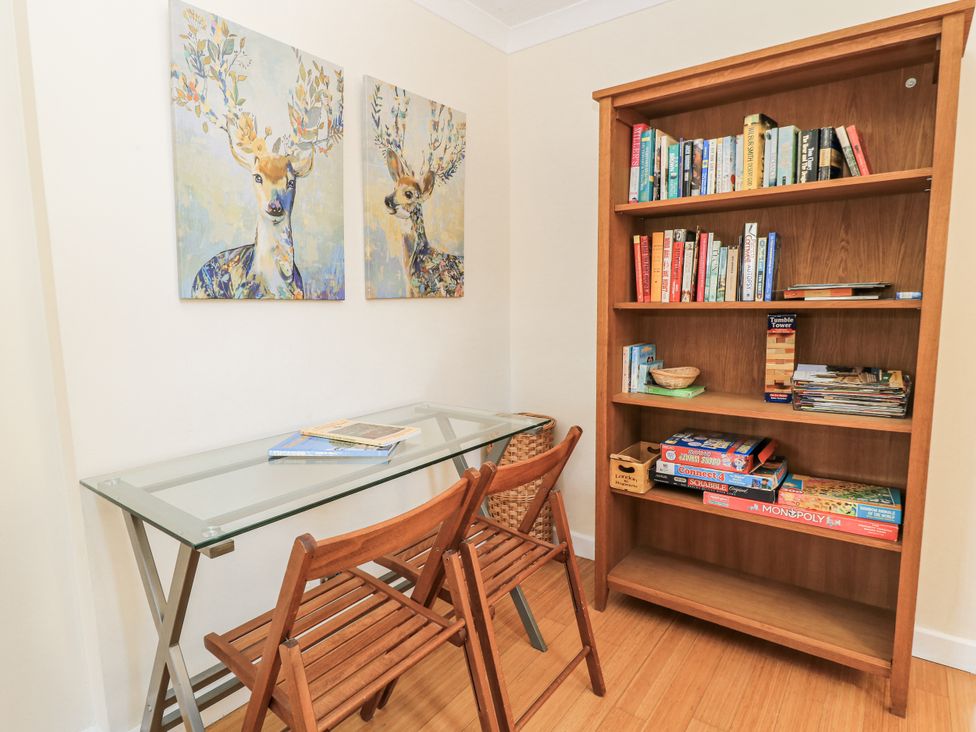 A study room with a table and bookshelf at White Stones, Fulbrook, near Burford