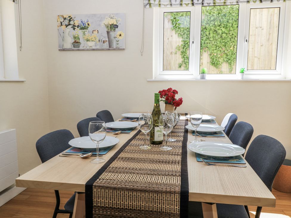 A dining room with a table set for dinner at White Stones in Fulbrook, near Burford