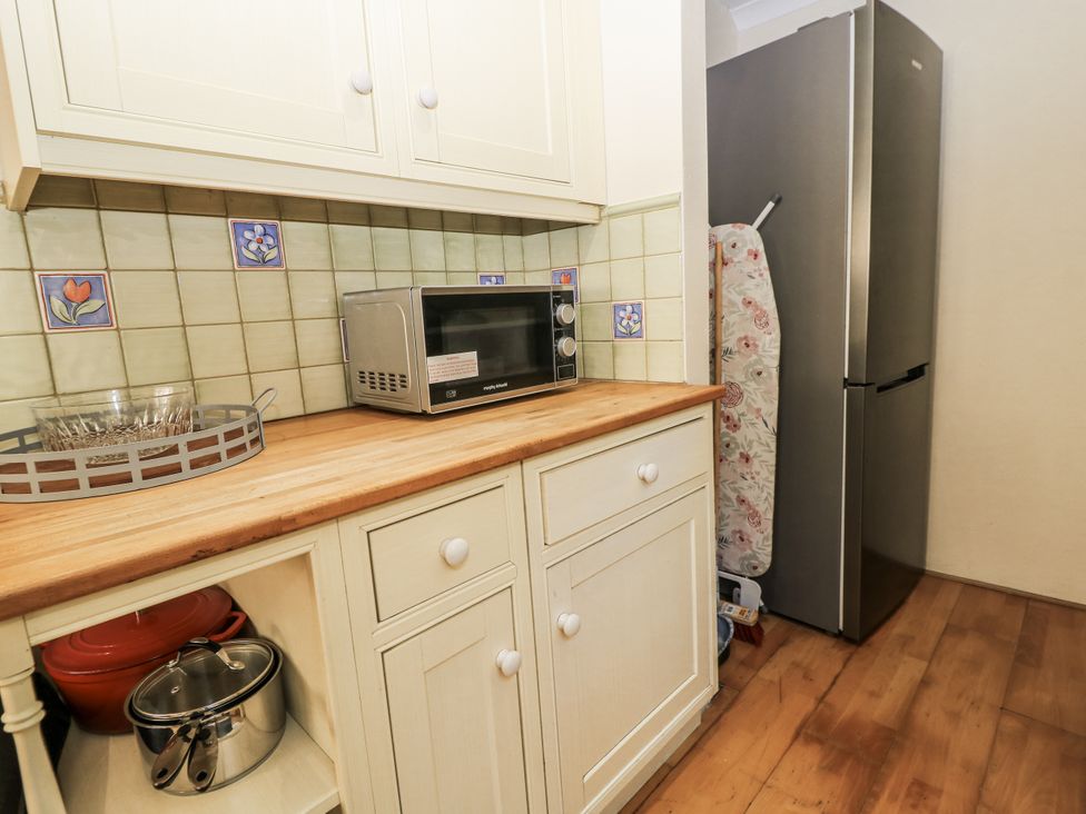 A kitchen with a microwave and refrigerator at White Stones Fulbrook, near Burford