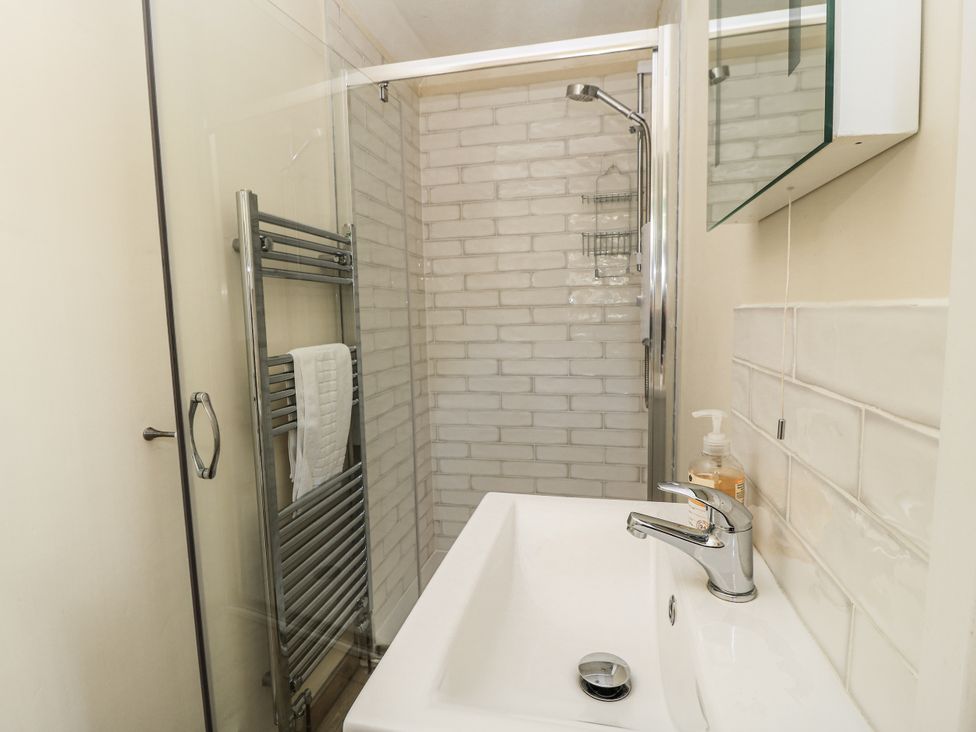 A bathroom with a shower and sink at White Stones, Fulbrook, near Burford