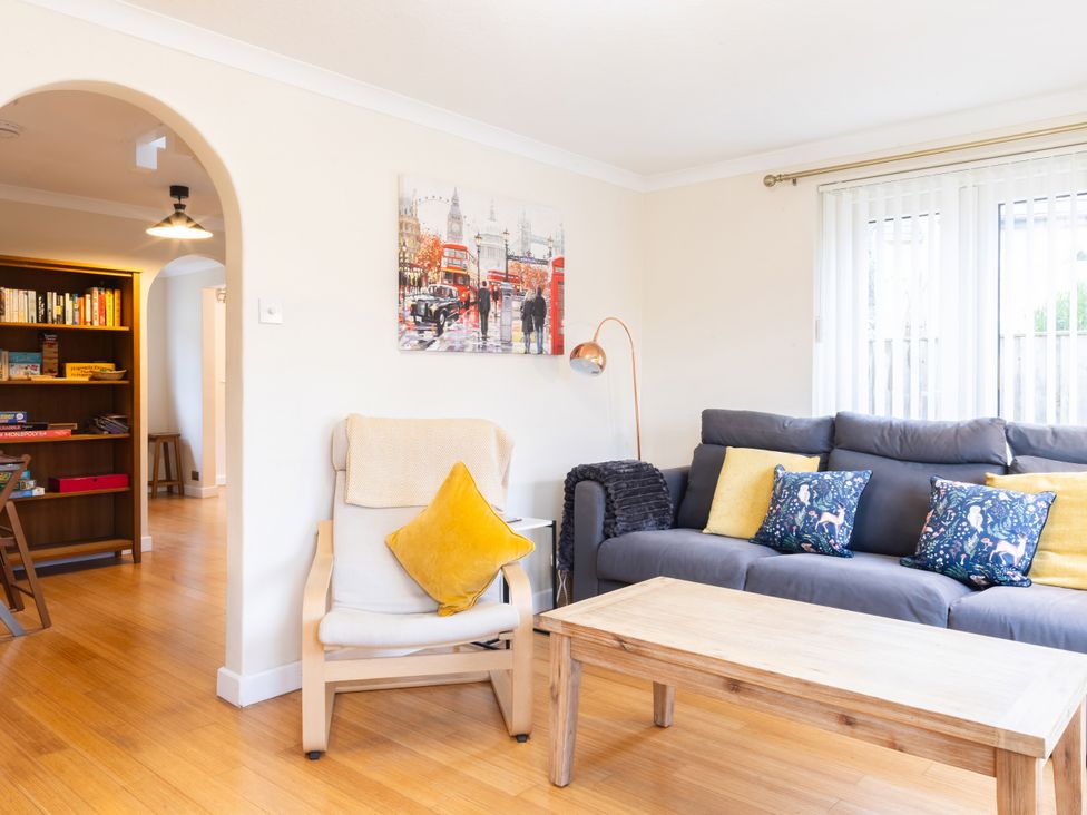 A living room with a sofa and a coffee table at White Stones in Fulbrook, near Burford