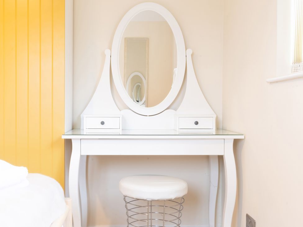 A vanity table with a mirror and stool at White Stones Fulbrook near Burford