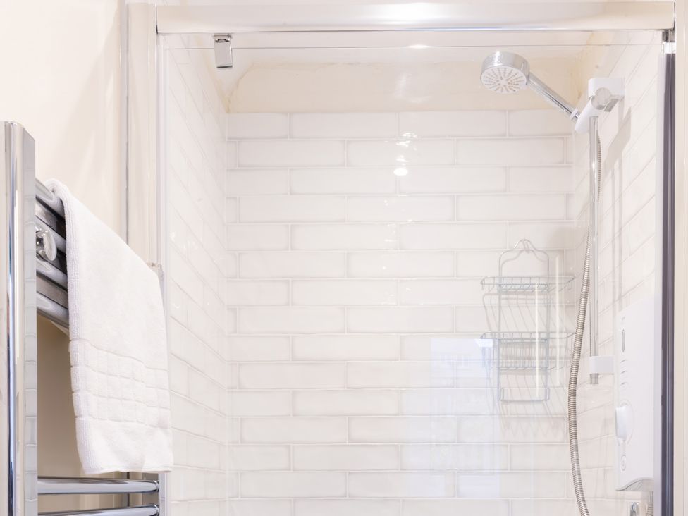 A shower with a towel rack and showerhead at White Stones in Fulbrook, near Burford