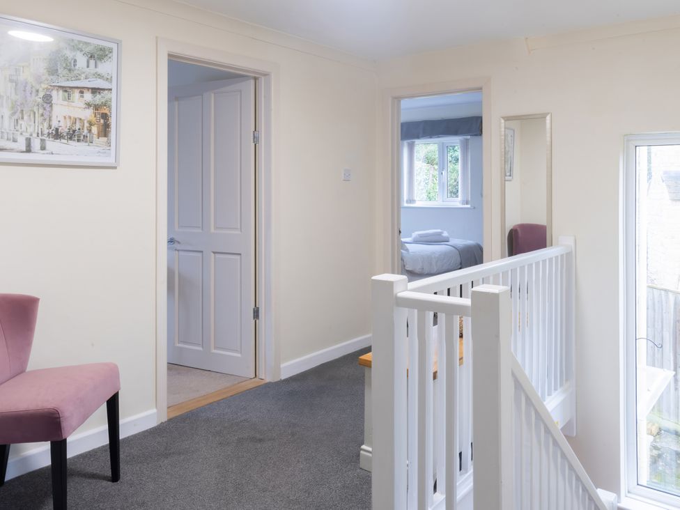 A hallway with a chair and doors at White Stones, Fulbrook, near Burford