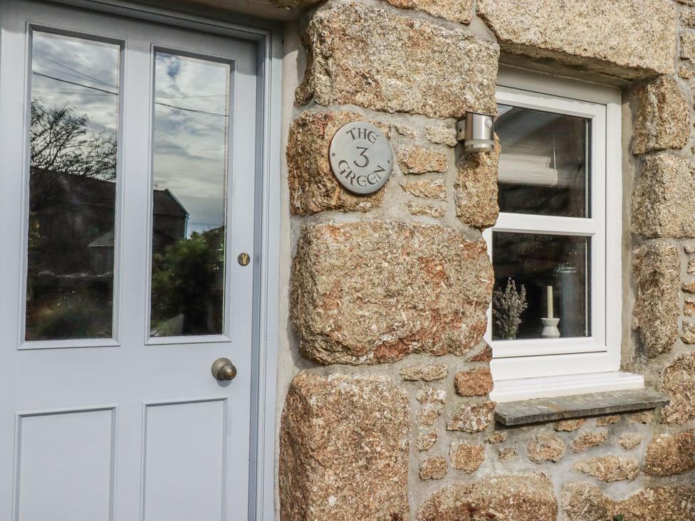 An entrance with a door and window at 3 The Green