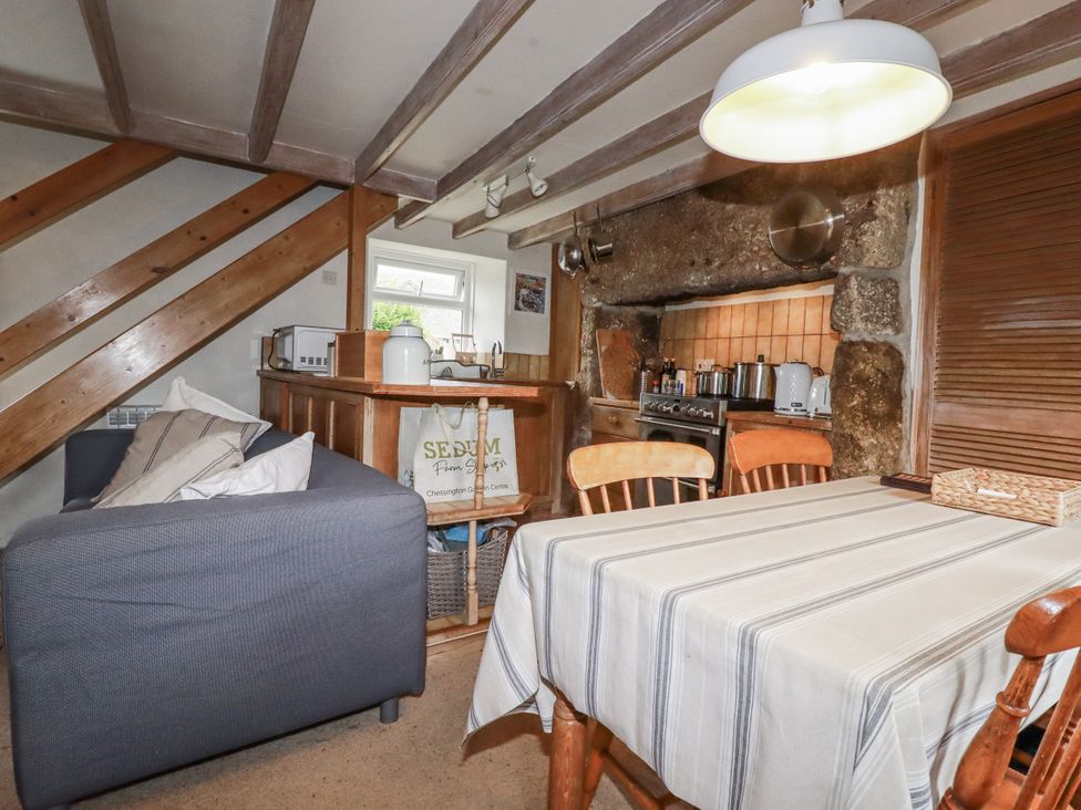 A dining room with a table and chairs at 3 The Green 