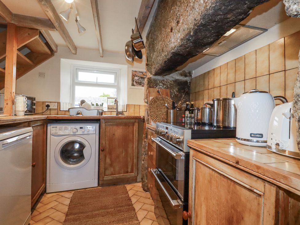 A kitchen with a washing machine and stove at 3 The Green