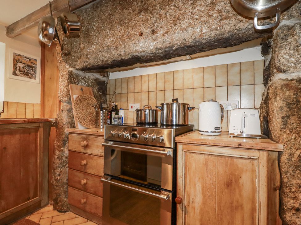 A kitchen with a stove and kettle at 3 The Green