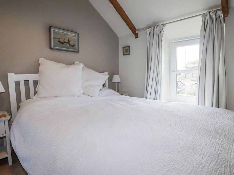 A bedroom with a bed and window at 3 The Green