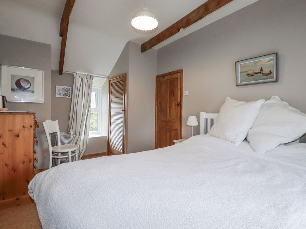 A bedroom with a bed and white pillows at 3 The Green