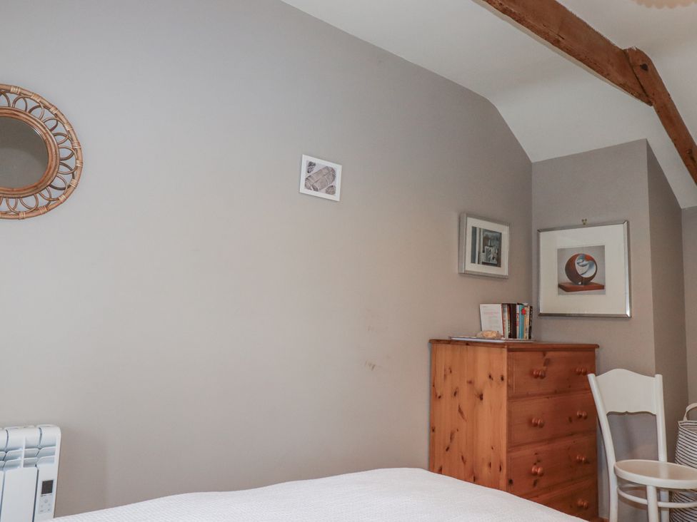 A bedroom with a mirror and a dresser at 3 The Green