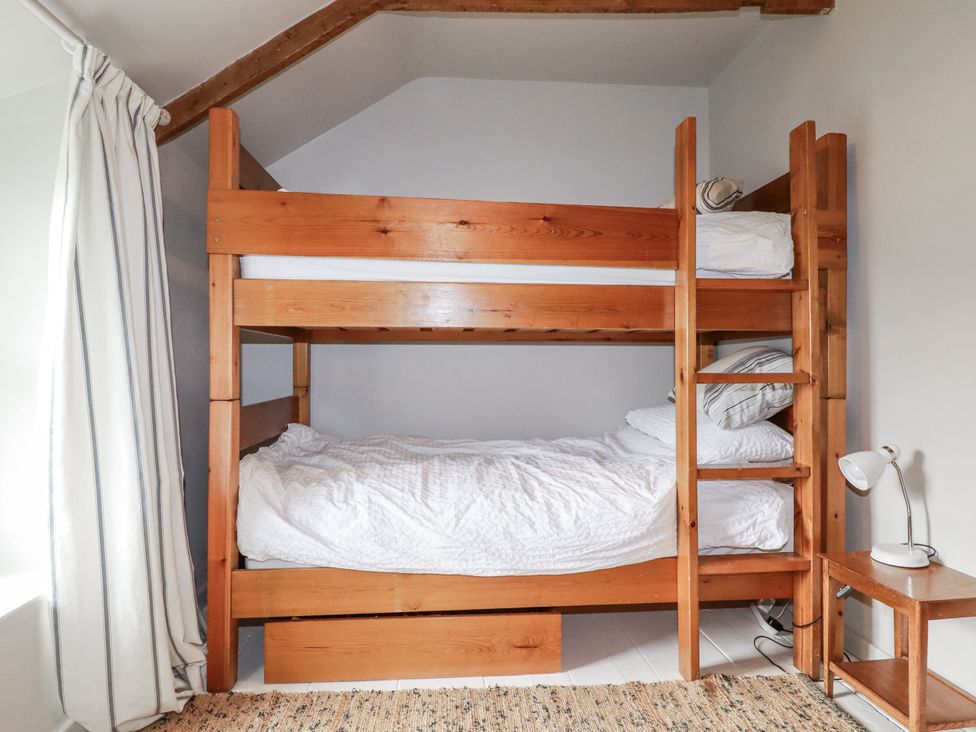 A bunk bed with mattresses in a bedroom at 3 The Green