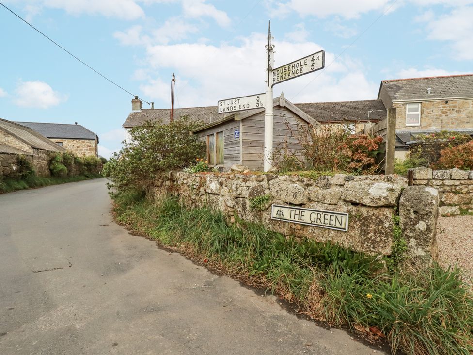 A road with a signpost and buildings at The Green