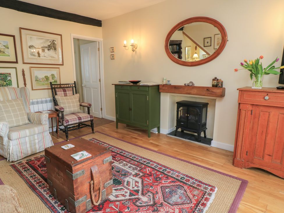 A living room with a table, cabinets, and artworks at 4 Duck Street in Dorchester