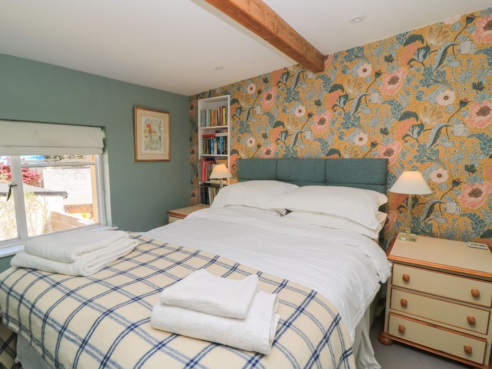 A bedroom with a bed and bookshelf at 4 Duck Street, Dorchester