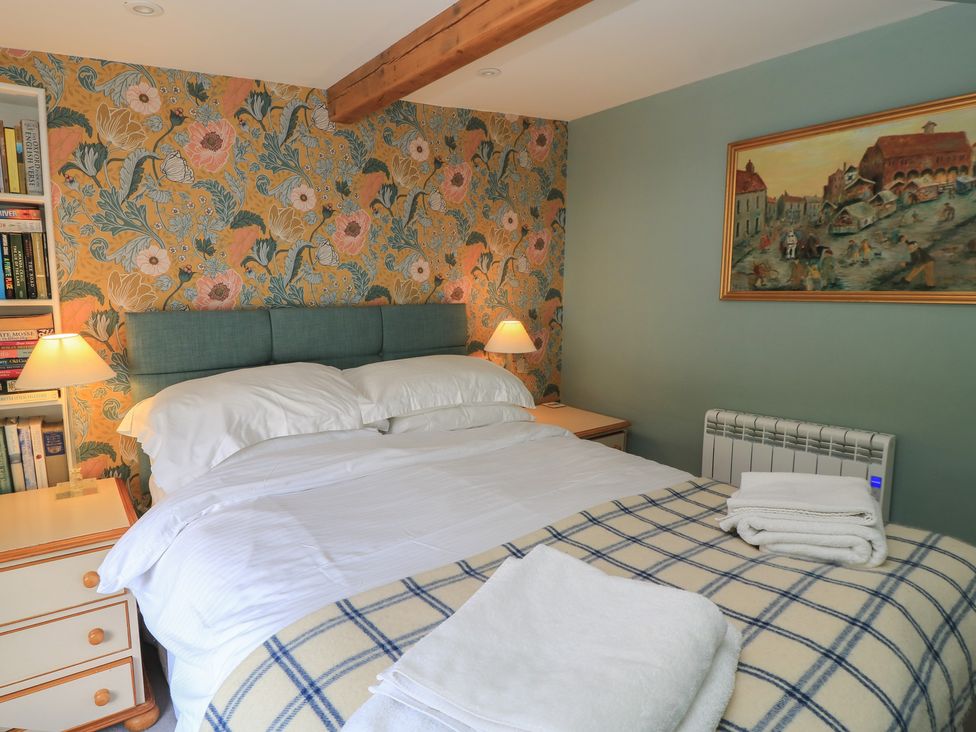 A bedroom with a bed and bookshelf at 4 Duck Street Dorchester