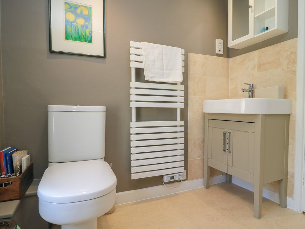 A bathroom with a toilet, washbasin, and towel rack at 4 Duck Street in Dorchester