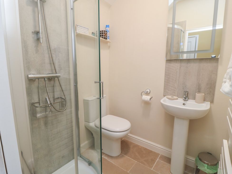 A bathroom with a shower, toilet, and sink at 4 Duck Street in Dorchester