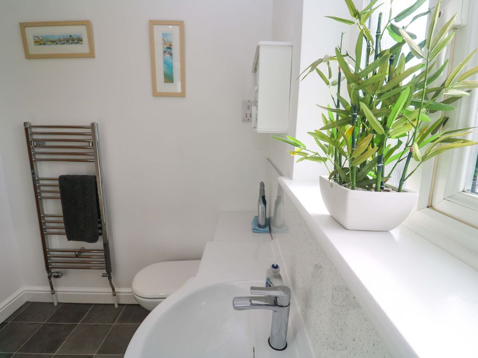 A bathroom with a sink and towel radiator at Cherry Tree House in Penzance