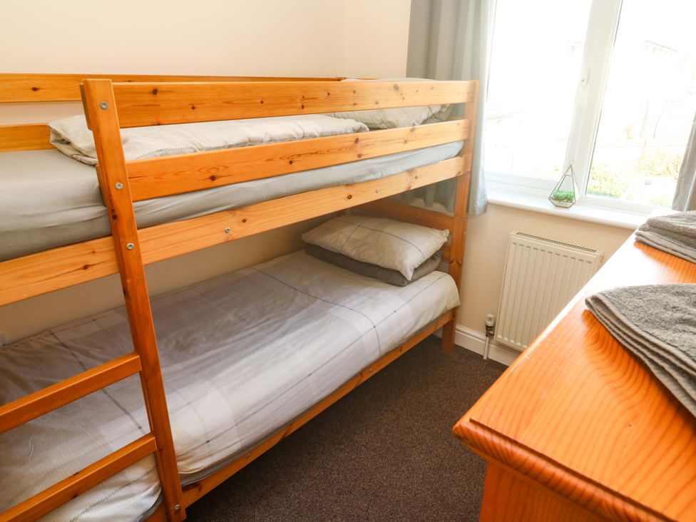 A bedroom with a bunk bed and a dresser at Cherry Tree House in Penzance