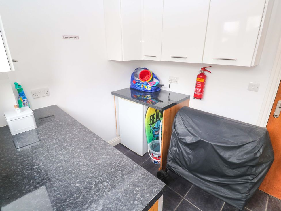 A laundry room with a countertop and cleaning supplies at Cherry Tree House in Penzance