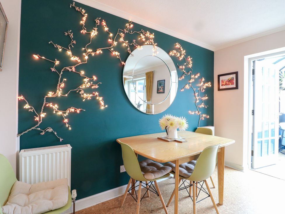 A dining room with a table and chairs at Coastguard Cottage in Rye