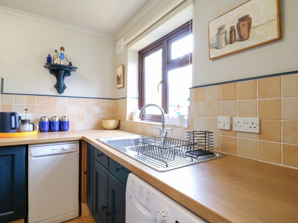 A kitchen with a sink and dishwasher at Coastguard Cottage in Rye
