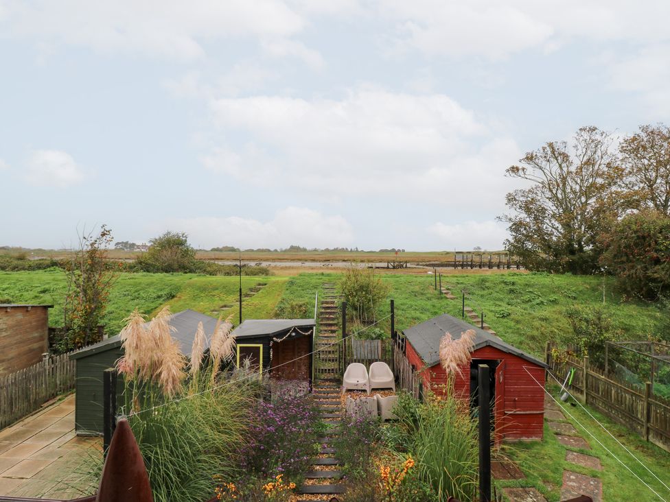 A garden with sheds and plants at Coastguard Cottage in Rye
